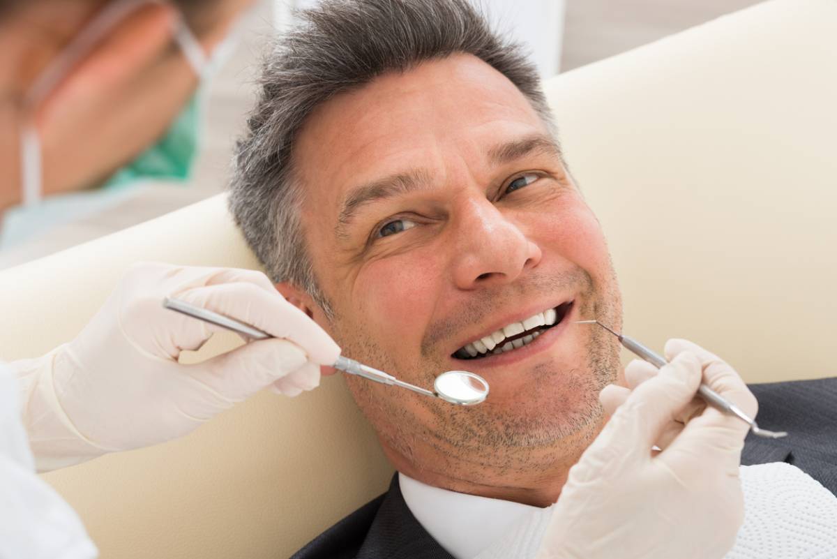 Man at the dentist getting fillings on time.