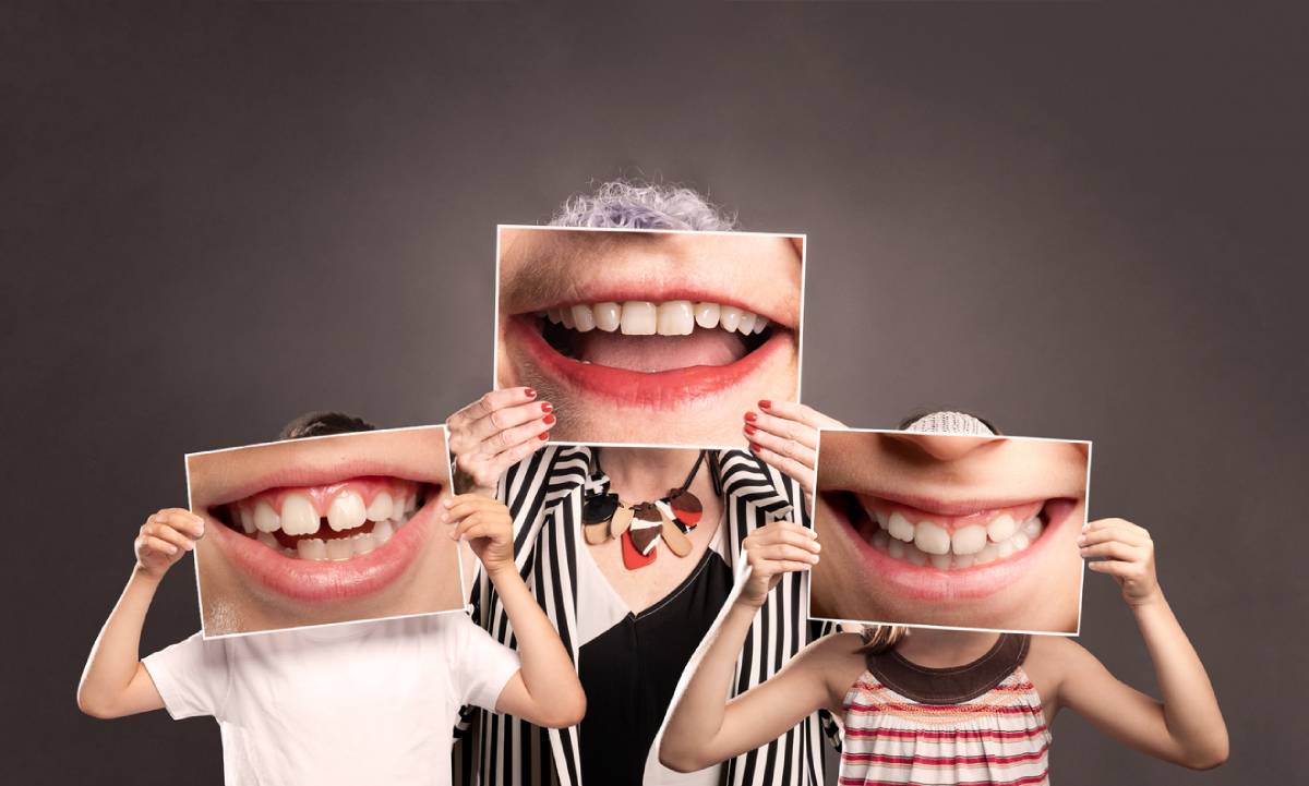 People smiling with big photos of healthy smiles.