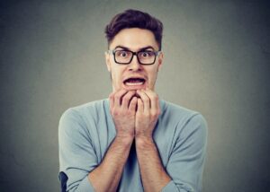 Man with root canal anxiety looking terrified.