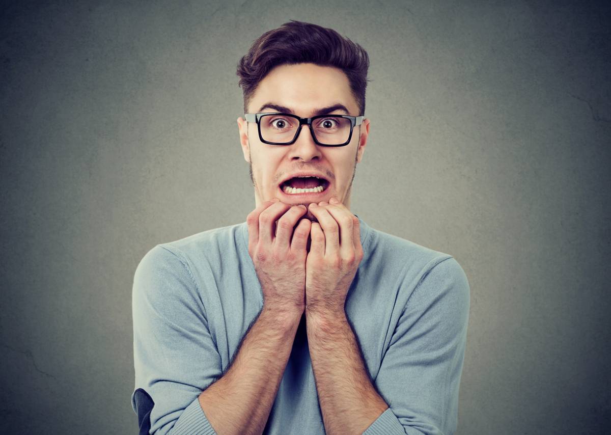 Man with root canal anxiety looking terrified.