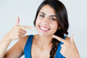 Woman smiling with white teeth and dental bonding.