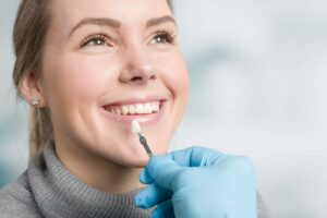 concept image of woman trying veneers to boost confidence
